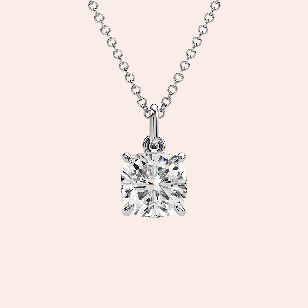 A detailed close-up of a cushion-cut solitaire diamond pendant set in a four-prong white gold basket. The refined craftsmanship highlights the brilliance of the diamond, making it a must-have piece for any fine jewelry collection.| #14KRecycledWhiteGold #18KRecycledWhiteGold