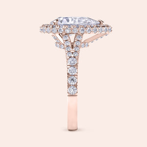 Rose gold pear diamond halo engagement ring with pavé band, intricate side view highlighting craftsmanship and brilliance 