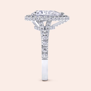 Pear shaped halo diamond ring in white gold with pavé band, elevated setting with detailed side profile and elegant structure 