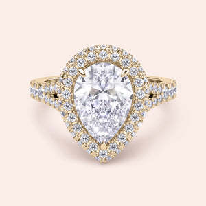 Pear shaped halo diamond ring in yellow gold with pavé band, elevated setting with detailed side profile and elegant structure 