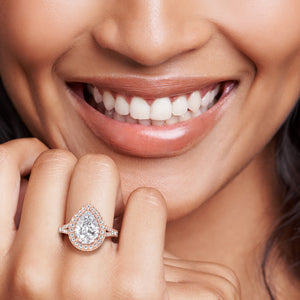 Rose gold pear shaped diamond ring with double halo, radiant engagement ring with soft romantic tone and luminous sparkle 