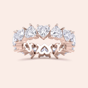 Heart diamond eternity band in rose gold, angled view showcasing prong setting, continuous heart shaped diamonds and craftsmanship details 