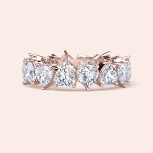 Heart shaped diamond eternity ring in rose gold, front view highlighting symmetry of heart diamonds and full eternity design 