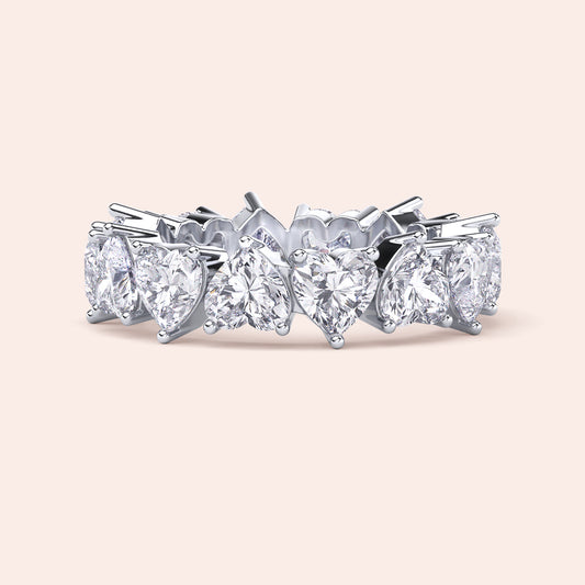 White gold heart diamond eternity ring, angled product view emphasizing prong setting and seamless alignment of heart shaped diamonds 