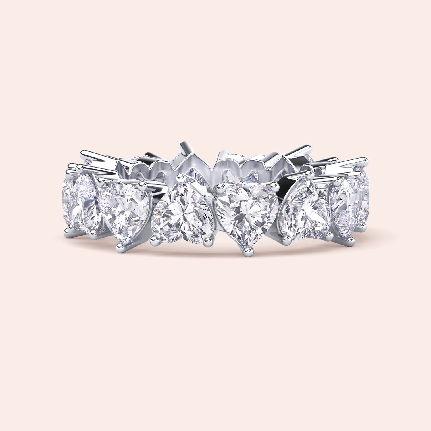White gold heart diamond eternity ring, angled product view emphasizing prong setting and seamless alignment of heart shaped diamonds 