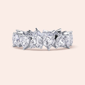White gold heart diamond eternity ring, angled product view emphasizing prong setting and seamless alignment of heart shaped diamonds 