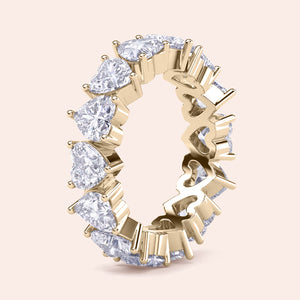 Heart diamond eternity band in yellow gold, vertical composition highlighting continuous diamond layout and craftsmanship 