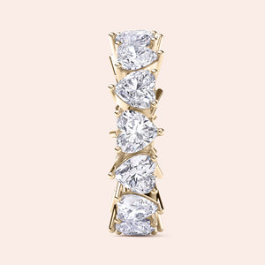 Yellow gold heart shaped diamond eternity ring, side profile showing elevated setting, prongs and dimensional design 