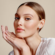 Matching pair of signature round halo diamond stud earrings in rose gold, symmetrical layout emphasizing balance and brilliance | #14KRecycledRoseGold #18KRecycledRoseGold