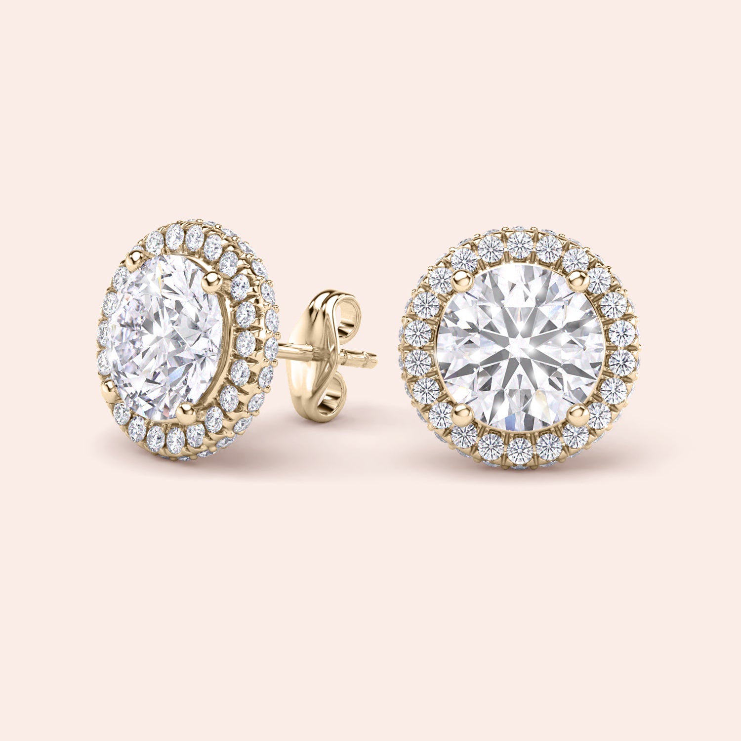 Matching pair of signature round halo diamond stud earrings in yellow gold, symmetrical layout emphasizing balance and brilliance | #14KRecycledYellowGold #18KRecycledYellowGold