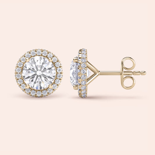 Signature round halo diamond stud earrings in yellow gold, close-up front view showcasing brilliant center diamonds surrounded by a sparkling halo 