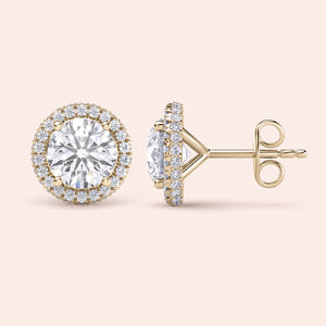 Signature round halo diamond stud earrings in yellow gold, close-up front view showcasing brilliant center diamonds surrounded by a sparkling halo 