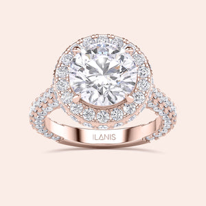 Round halo diamond engagement ring in recycled rose gold, top angle view with pavé diamond band. 