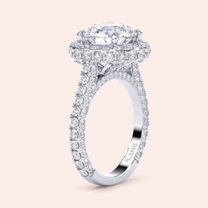 Round halo diamond engagement ring in white gold, front view of pavé band and halo bridal setting 