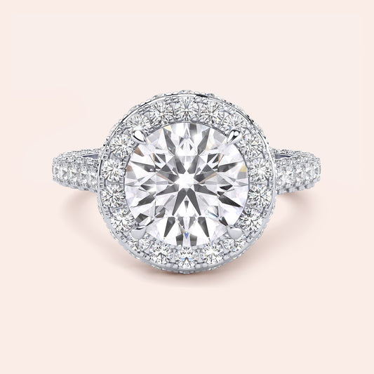 White gold round halo engagement ring, top view showing center diamond, halo and pavé shank 
