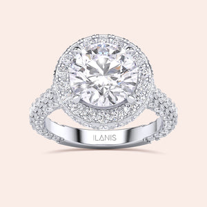 Round halo diamond engagement ring in white gold, side profile showing elevated setting and pavé band 