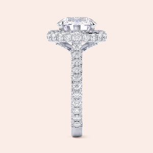 Round halo diamond engagement ring in white gold, side profile showing elevated setting and pavé band 