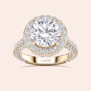 Yellow gold round halo engagement ring, top view showing center diamond, halo and pavé shank 