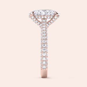 Rose gold oval diamond engagement ring, side view showing elevated hidden halo and pavé shank 
