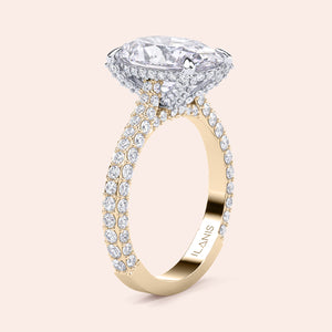 Oval diamond engagement ring in two tone yellow and white gold, side angle showcasing pavé band and hidden halo design 
