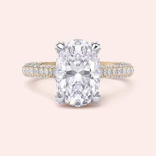 Two tone yellow and white gold oval engagement ring, front view with white gold prongs and yellow gold diamond band 