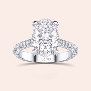 Oval diamond engagement ring in white gold, top view with pavé band and solitaire setting 