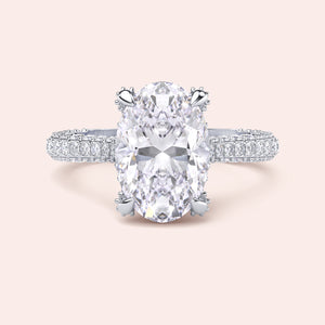White gold oval diamond engagement ring, front view with pavé band and cat claw prongs 