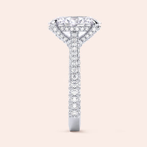 White gold oval diamond engagement ring, side view showing elevated hidden halo and pavé shank 