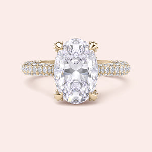 Yellow gold oval diamond engagement ring, straight-on front view with pavé shank and claw prongs 