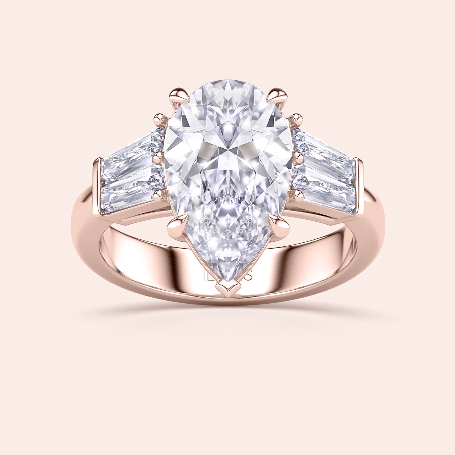 Rose gold pear diamond engagement ring, front view featuring central pear cut diamond with tapered baguette side stones | #14KRecycledRoseGold #18KRecycledRoseGold