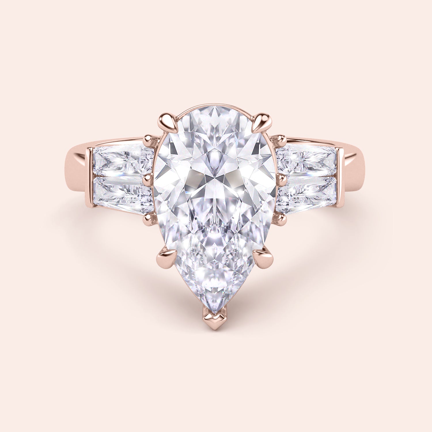 Pear cut diamond three stone ring in rose gold, top view with elegant prong setting and baguette side diamonds | #14KRecycledRoseGold #18KRecycledRoseGold