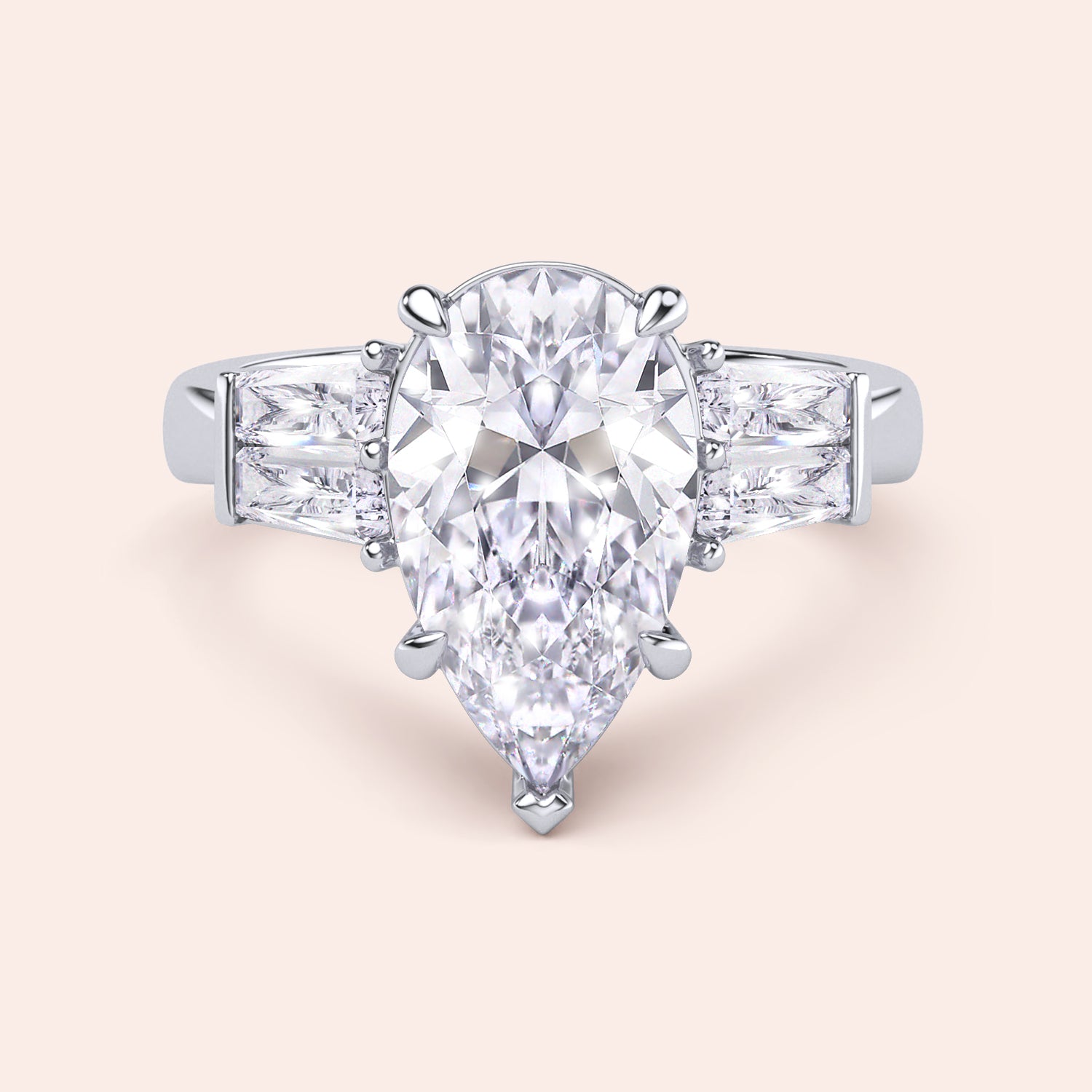Pear diamond three stone ring in white gold, top view highlighting symmetry of center stone and baguette side diamonds | #14KRecycledWhiteGold #18KRecycledWhiteGold #platinum