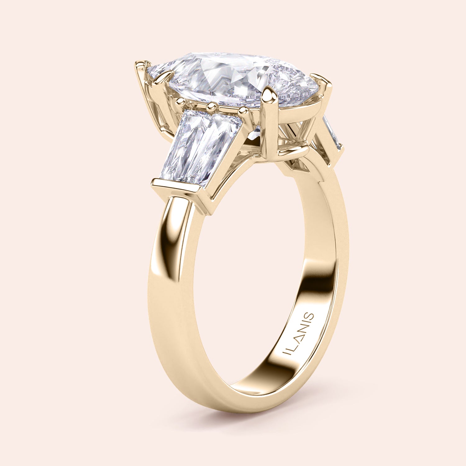 Pear cut diamond three stone engagement ring in yellow gold, side profile showcasing elevated setting and tapered baguette side stones | #14KRecycledYellowGold #18KRecycledYellowGold