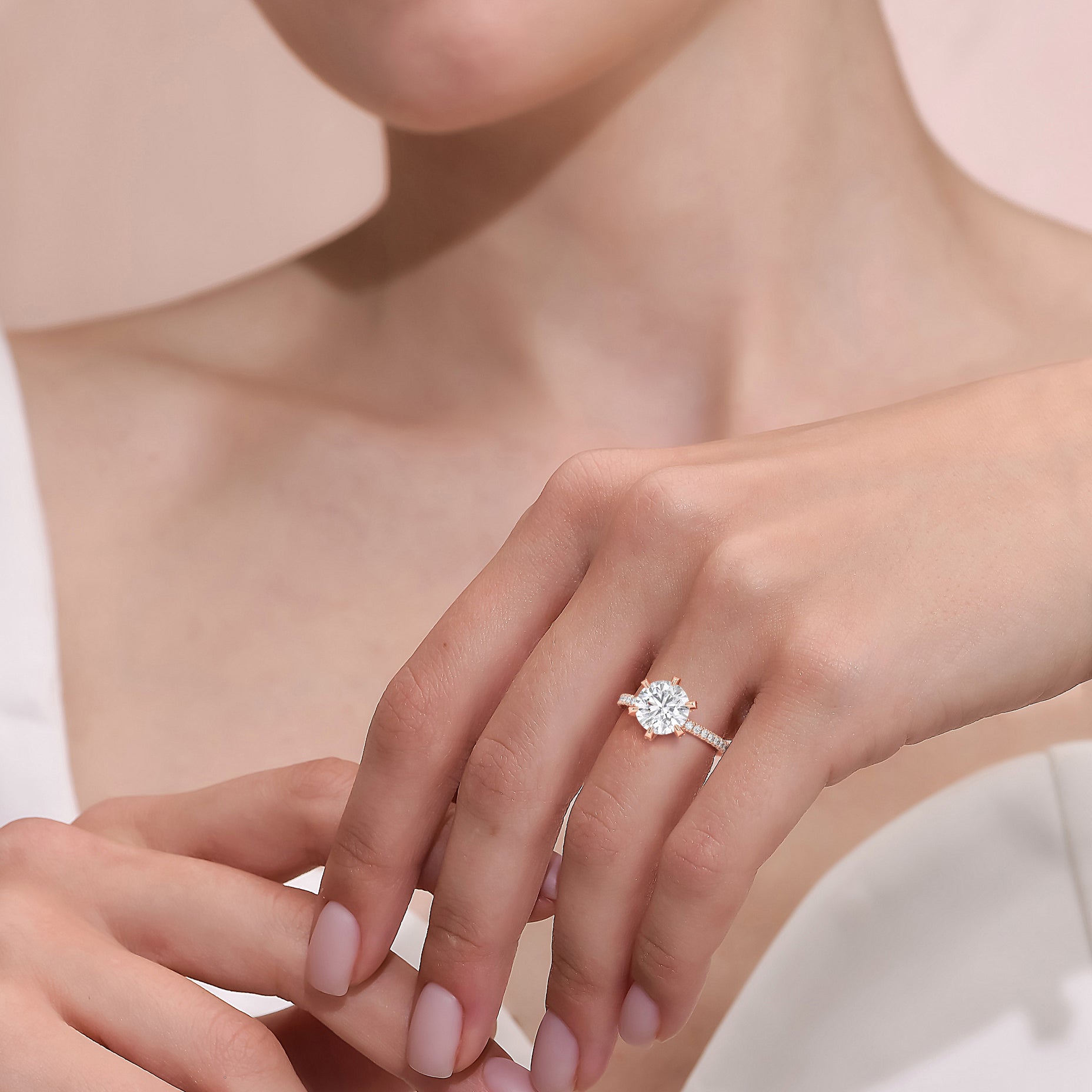 Rose gold round solitaire diamond engagement ring with pavé band worn on hand, close-up showcasing center stone brilliance and delicate setting | #14KRecycledRoseGold #18KRecycledRoseGold