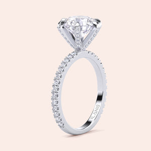 Vertical side view of white gold or platinum diamond engagement ring with pavé band, highlighting fine detailing and structured setting 
