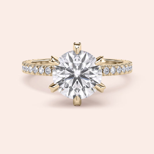 Yellow gold diamond engagement ring side profile showing pavé band, accent diamond prongs and elevated gallery design 