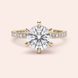 Yellow gold diamond engagement ring side profile showing pavé band, accent diamond prongs and elevated gallery design 