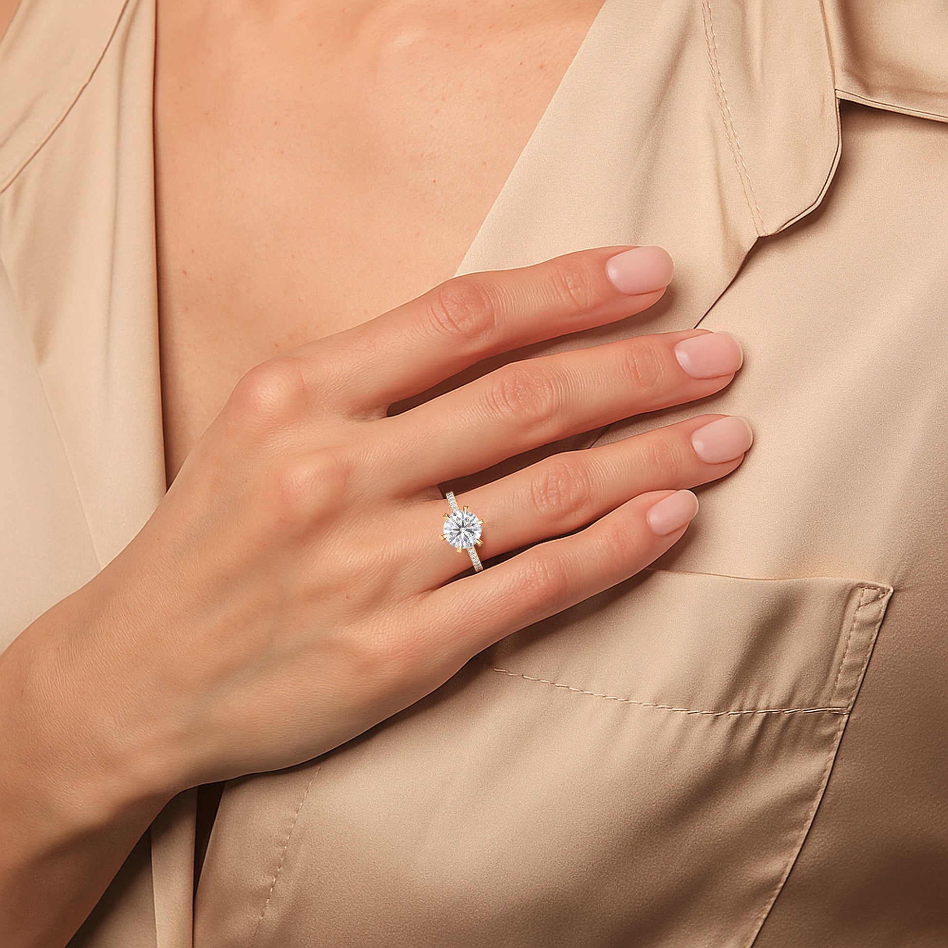 Yellow gold round solitaire diamond engagement ring with pavé band worn on hand, close-up highlighting center stone brilliance and warm gold contrast | #14KRecycledYellowGold #18KRecycledYellowGold