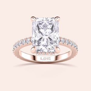 Side profile of rose gold radiant cut diamond engagement ring with pavé band and accent diamonds on prongs, showcasing elevated gallery and craftsmanship 
