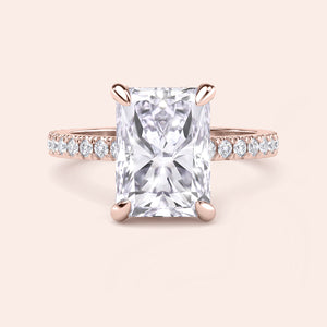 Front view of radiant cut diamond engagement ring in rose gold with pavé band, emphasizing symmetry, fire and center stone brilliance 