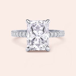 Front view of radiant cut diamond engagement ring in white gold with pavé band, emphasizing symmetry, brilliance and center stone presence 