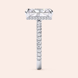Side profile of white gold radiant cut diamond engagement ring with pavé band and accent diamonds on prongs, showcasing elevated gallery and craftsmanship 