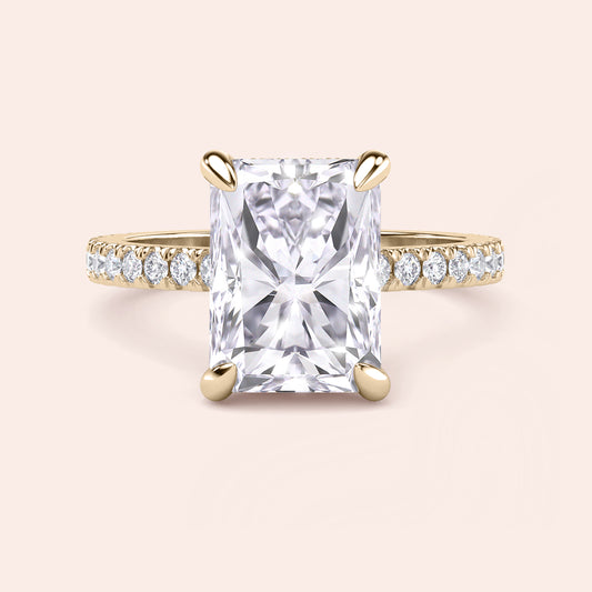 Front view of radiant cut diamond engagement ring in yellow gold with pavé band, highlighting symmetry, brilliance and center stone presence 