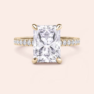 Front view of radiant cut diamond engagement ring in yellow gold with pavé band, highlighting symmetry, brilliance and center stone presence 