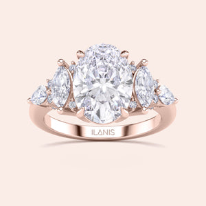 Oval cut three stone diamond engagement ring yellow gold with pear side stones front view, classic oval center diamond ring, luxury bridal jewelry design 