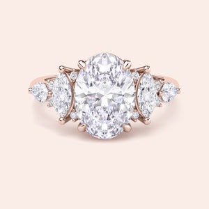 Oval diamond engagement ring yellow gold top view with pear side stones, high clarity oval cut center stone, fine jewelry engagement ring close up 