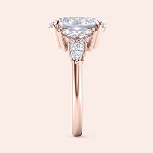 Rose gold oval three stone diamond engagement ring vertical side view with pear side stones, detailed craftsmanship and premium bridal design 