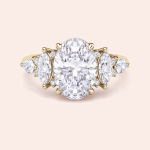 Yellow gold oval diamond three stone engagement ring side profile with pear side stones, elevated setting and handcrafted fine jewelry detail 