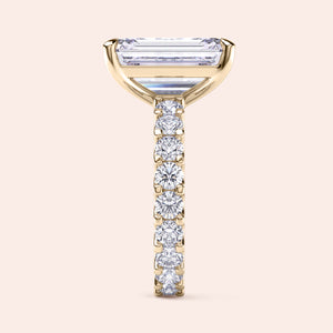 Emerald cut diamond engagement ring yellow gold with full eternity diamond band, side profile view, modern hidden setting, luxury bridal ring 
