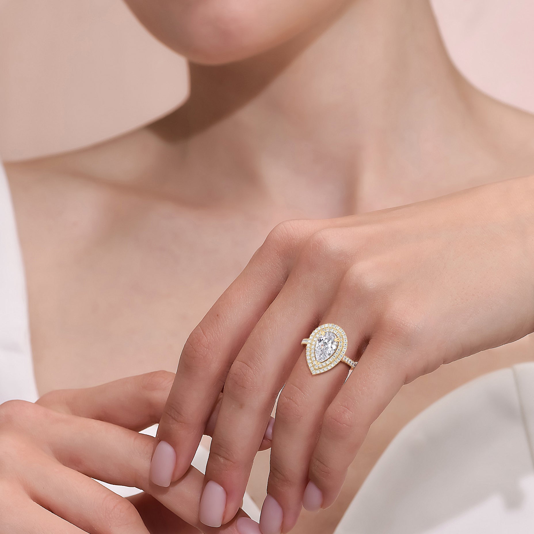 Pear diamond engagement ring yellow gold worn on hand, double halo setting with pavé band, timeless and romantic look | #14KRecycledYellowGold #18KRecycledYellowGold